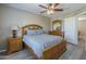This bedroom features modern flooring, a wooden bed frame and matching bedside tables and dresser at 6847 S 27Th Pl, Phoenix, AZ 85042