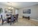 Neutral dining room with travertine tile, and a painting of a lakeside village on the wall at 6847 S 27Th Pl, Phoenix, AZ 85042
