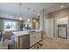 Bright open-concept kitchen with a large island, modern stainless steel appliances, and seamless flow to living area at 6847 S 27Th Pl, Phoenix, AZ 85042