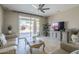 Bright living room features travertine floors, a ceiling fan, and a view of the backyard pool at 6847 S 27Th Pl, Phoenix, AZ 85042
