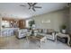 Open-concept living area with travertine flooring seamlessly connecting the living room and kitchen at 6847 S 27Th Pl, Phoenix, AZ 85042