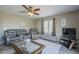 Relaxing living room with a ceiling fan, a TV, and a view of the home's exterior through the window at 6847 S 27Th Pl, Phoenix, AZ 85042