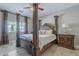 Luxurious main bedroom suite with hardwood floors, decorative wooden pillars, and high ceilings at 6847 S 27Th Pl, Phoenix, AZ 85042