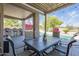 Outdoor patio with a shaded dining area, bar seating, and views of the pool and greenery at 6847 S 27Th Pl, Phoenix, AZ 85042