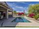 Backyard oasis with a pool, spa, patio area, outdoor kitchen and colorful landscaping at 6847 S 27Th Pl, Phoenix, AZ 85042