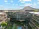 Stunning aerial view of the multi-story building with lush landscaping, a refreshing pool, and majestic mountain views at 7121 E Rancho Vista Dr # 6001, Scottsdale, AZ 85251