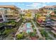 Stunning aerial view of luxurious condos with beautiful landscaping and a sparkling pool at 7121 E Rancho Vista Dr # 6001, Scottsdale, AZ 85251