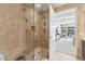 Modern bathroom with glass shower and stone tile, creating a spa-like experience with a view into the bedroom at 7121 E Rancho Vista Dr # 6001, Scottsdale, AZ 85251