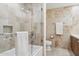 Contemporary bathroom featuring a bathtub, glass shower, and modern toilet set against a neutral-toned tile backdrop at 7121 E Rancho Vista Dr # 6001, Scottsdale, AZ 85251