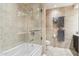 Modern bathroom featuring a tiled bathtub, shower, and glass door, alongside stylish fixtures and neutral decor at 7121 E Rancho Vista Dr # 6001, Scottsdale, AZ 85251