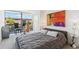 This is a spacious bedroom with a modern bed, colorful art, and a beautiful view of the outdoors at 7121 E Rancho Vista Dr # 6001, Scottsdale, AZ 85251
