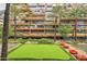 Community green featuring putting green and lounge seating with palm trees and exterior building view at 7121 E Rancho Vista Dr # 6001, Scottsdale, AZ 85251