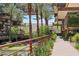 Serene courtyard view with walking path, water feature, and landscaping framed by palm trees at 7121 E Rancho Vista Dr # 6001, Scottsdale, AZ 85251