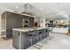 Modern kitchen with gray cabinetry, stainless steel appliances, a center island with barstool seating, and granite countertops at 7121 E Rancho Vista Dr # 6001, Scottsdale, AZ 85251
