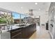 Contemporary kitchen featuring a large island with seating, granite countertops, and floor-to-ceiling windows with great views at 7121 E Rancho Vista Dr # 6001, Scottsdale, AZ 85251
