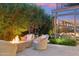 Inviting outdoor patio with a fire pit, comfortable seating, and lush landscaping at 7121 E Rancho Vista Dr # 6001, Scottsdale, AZ 85251