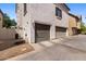 Exterior elevation of the home featuring multiple garage doors and a stucco finish at 753 N Port Dr, Gilbert, AZ 85233