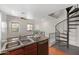 Modern kitchen with an island, a breakfast bar, and access to the living area and spiral staircase at 753 N Port Dr, Gilbert, AZ 85233