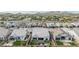 Drone shot of a backyard featuring artificial turf, a pergola, and mountain views in a housing community at 8127 E June St, Mesa, AZ 85207