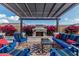 Cozy outdoor seating area with a fireplace, surrounded by lush greenery, perfect for relaxing evenings and entertaining guests at 8127 E June St, Mesa, AZ 85207