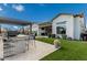 Outdoor kitchen and seating area, complete with artificial turf, offering a perfect blend of style and functionality at 8127 E June St, Mesa, AZ 85207