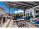 Inviting outdoor seating area with a fireplace, comfortable seating, and lush landscaping, creating a perfect outdoor retreat at 8127 E June St, Mesa, AZ 85207