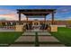 Inviting backyard patio with fireplace, comfortable seating, and outdoor grill, perfect for entertaining guests at 8127 E June St, Mesa, AZ 85207
