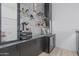 Modern bar area with glass shelves, sleek cabinets, and a beverage refrigerator for showcasing drinks and accessories at 8127 E June St, Mesa, AZ 85207