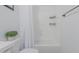 White bathroom features a new bathtub with white shower curtain and modern vanity at 8127 E June St, Mesa, AZ 85207