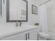 Updated bathroom boasts modern vanity with quartz countertops, matte black fixtures, and a shower at 8127 E June St, Mesa, AZ 85207