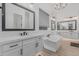 Bright bathroom with dual sinks, a soaking tub, and modern fixtures with lots of natural light at 8127 E June St, Mesa, AZ 85207