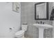 Stylish powder room features patterned tile, pedestal sink, and modern fixtures at 8127 E June St, Mesa, AZ 85207