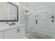 Modern bathroom with white marble tile, glass shower, and sleek fixtures at 8127 E June St, Mesa, AZ 85207