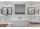 Bright bathroom with dual sinks, a soaking tub, and modern fixtures at 8127 E June St, Mesa, AZ 85207