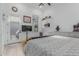 The bedroom features white walls, a white patterned comforter, and light-colored wood-look flooring at 8127 E June St, Mesa, AZ 85207