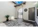 Charming courtyard featuring decorative sun decor and wrought-iron gate, complemented by textured paving stones at 8127 E June St, Mesa, AZ 85207