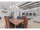 Open-concept layout with a dining table, chandelier, and seating adjacent to the bright and spacious living area at 8127 E June St, Mesa, AZ 85207