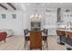 Formal dining area featuring a chandelier, long table with seating for six, and modern white brick walls at 8127 E June St, Mesa, AZ 85207