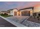Single Gathering home with a paver driveway, two-car garage, and desert landscaping at 8127 E June St, Mesa, AZ 85207