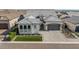 Beautiful home featuring a manicured lawn, elegant brickwork, and a stylish entrance with a driveway, showcasing curb appeal at 8127 E June St, Mesa, AZ 85207