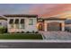 Charming single-Gathering home boasts a paver driveway, two-car garage, and manicured front yard with beautiful desert plants at 8127 E June St, Mesa, AZ 85207