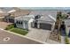 An eye-level view of the house featuring a paver driveway leading up to a two-car garage with desert landscaping at 8127 E June St, Mesa, AZ 85207