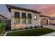 Charming single-Gathering home boasts a paver driveway, two-car garage, and manicured front yard with beautiful desert plants at 8127 E June St, Mesa, AZ 85207