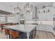 Modern kitchen with a central island, stainless steel appliances, and custom cabinetry offering ample storage at 8127 E June St, Mesa, AZ 85207