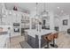 Contemporary kitchen island featuring a white countertop, bar stools, and stylish pendant lighting for a gourmet cooking experience at 8127 E June St, Mesa, AZ 85207