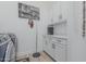 This clean laundry room boasts white cabinets and modern appliances at 8127 E June St, Mesa, AZ 85207