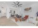 Open-concept living room showcasing modern furniture, seamless transitions to the kitchen and bar areas, and a sleek aesthetic at 8127 E June St, Mesa, AZ 85207