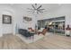 Bright living room featuring modern furniture, white wood paneled ceiling, and seamless indoor-outdoor living with sliding glass doors at 8127 E June St, Mesa, AZ 85207