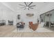 Open-concept living room with modern furniture, a large sliding glass door, and access to the kitchen and dining area at 8127 E June St, Mesa, AZ 85207