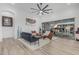 Bright living room featuring modern furniture, white wood paneled ceiling, and seamless indoor-outdoor living with sliding glass doors at 8127 E June St, Mesa, AZ 85207